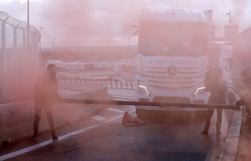 French fishermen light flares and block the road at the Eurotunnel Freight Terminal in Coquelles. Reuters