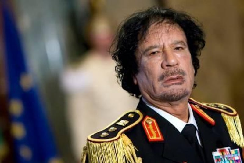 Libya's leader Muammar Gaddafi looks on during a news conference at the Quirinale Palace in Rome in this June 10, 2009 file photo. Libyan government tanks and snipers put up scattered, last-ditch resistance in Tripoli on August 22, 2011 after rebels swept into the heart of the capital, cheered on by crowds hailing the end of Gaddafi's 42 years in power. REUTERS/Max Rossi/Files (ITALY - Tags: POLITICS MILITARY IMAGES OF THE DAY CONFLICT) *** Local Caption ***  GAD128_LIBYA-_0822_11.JPG