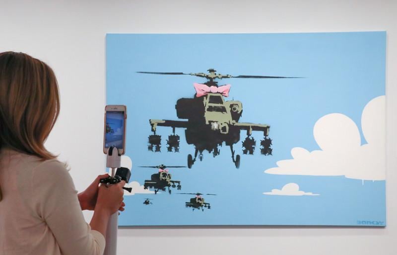 epa07017553 A piece by the street artist Banksy, acquired by actor Robin Williams is among his auction items on display in Los Angeles, California, USA, 12 September 2018  (issued 13 September 2018). The October auction of hundreds of artworks, movie props, toys and sports memorabilia from 'Creating a Stage: The Collection of Marsha and Robin Williams' will take place in New York.  EPA-EFE/EUGENE GARCIA