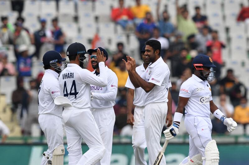 Sri Lanka's Charith Asalanka walks back to the pavilion as India's Ravichandran Ashwin celebrates his dismissal. AFP