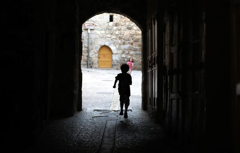 A child walks on an empty street in the old city of the West bank town of Hebron.  EPA