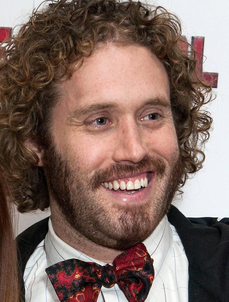 FILE - In this Jan. 28, 2016 file photo, actor TJ Miller poses for photos at a fan screening for the film "Deadpool," in central London. Miller was arrested Monday night, April 9, 2018, at LaGuardia Airport in New York and charged with calling 911 to falsely claim that a woman on the same train as him had a bomb in her luggage. Prosecutors said Miller called in the false bomb information on March 18 after getting into a verbal confrontation with a woman on a train traveling from Washington D.C. to New York. The train was stopped in Westport, Conn., where it was searched. (Photo by Grant Pollard/Invision/AP, File)