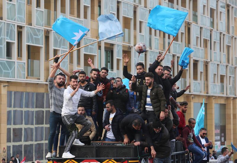 Supporters of Lebanon's former prime minister Saad Hariri carry flags as they ride on a pick up truck, marking the 15th anniversary of the assassination of his father, former Lebanese prime minister Rafik Hariri, in Beirut, Lebanon. Reuters