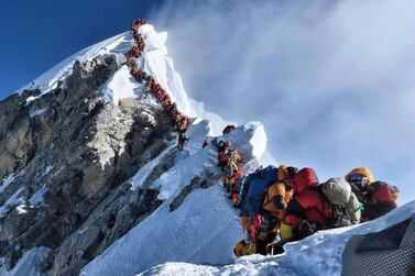 A long queue of mountain climbers line a path waiting to reach the summit Mount Everest during the deadliest climbing season in four years. AP