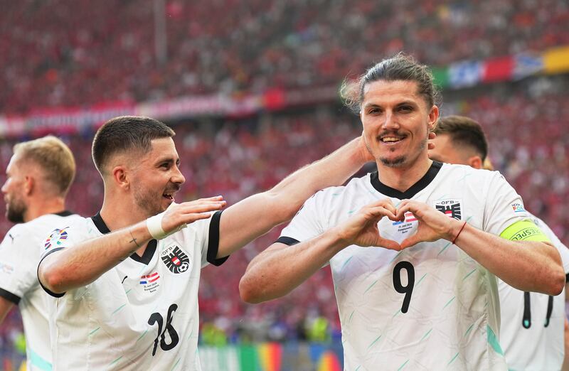 Austria's Marcel Sabitzer, right, celebrates after scoring his side's third goal in their 3-2 Euro 2024 Group D win over the Netherlands in Berlin on Tuesday, June 25, 2024. The victory meant that Austria topped the group ahead of France in second place. AP