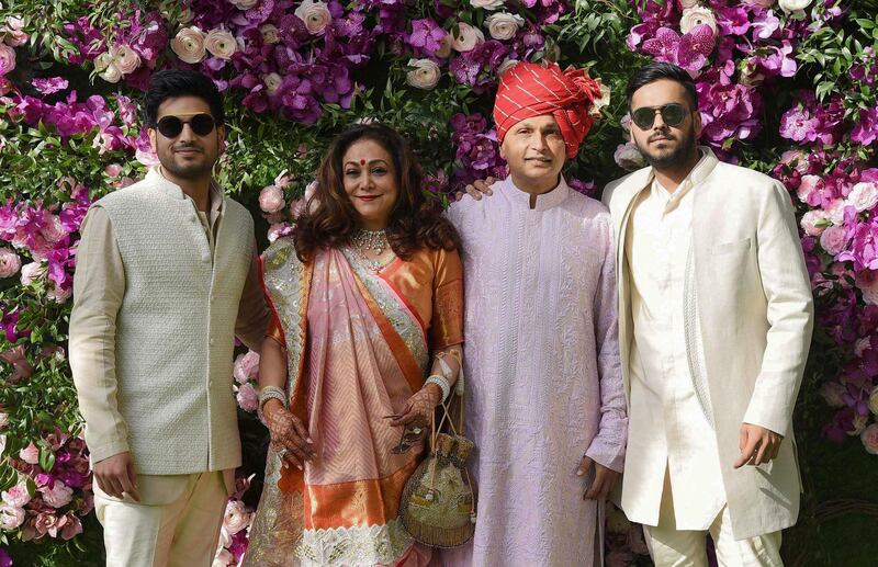 Indian businessman Anil Ambani (2nd R) poses for photographs along with his wife and former Bollywood actress Tina Ambani (2nd L) and their sons, Anshul Ambani (R) and Anmol Ambani (L). Photo: AFP