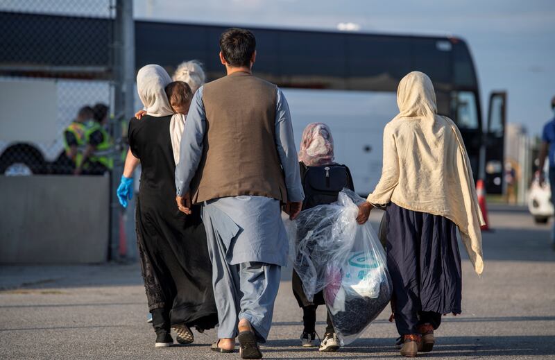 Afghan refugees prepare to board buses after arriving at Toronto Pearson International Airport in August 2021. Reuters