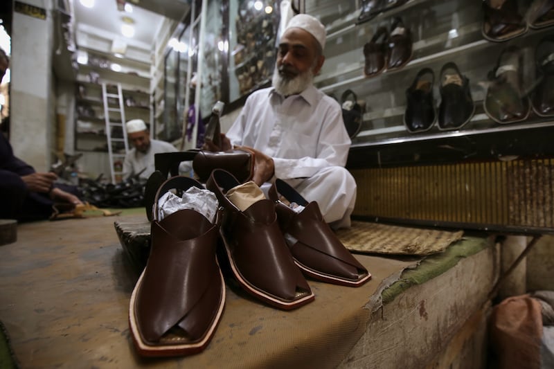 A cobbler makes traditional Peshawari chappal shoes before  Eid Al Fitr in Peshawar, Pakistan. EPA
