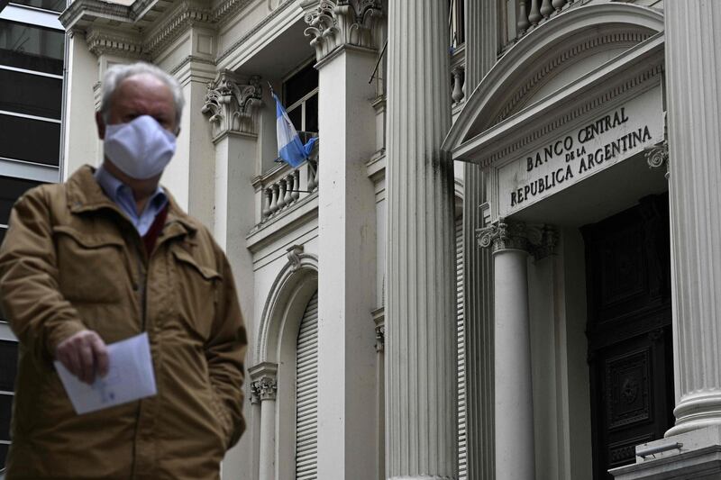 A man walks past Argentina's Central Bank during the lockdown imposed by the government against the spread of the new coronavirus, in Buenos Aires, on May 22, 2020.  Argentina was teetering on the brink of a second default this century on Friday as the deadline for a $500 million bond interest repayment approached. On Thursday, the economy ministry announced that it had postponed talks for a second time with international creditors on the restructuring of $66 billion of debt, this time until June 2. The negotiations were supposed to be completed by May 8 but had already been extended until Friday.
 / AFP / JUAN MABROMATA
