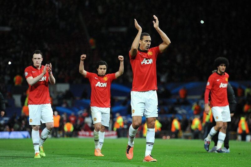 Manchester United players Phil Jones, left, Rafael, second left, Rio Ferdinand, second right and Marouane Fellaini celebrate their 3-0 victory as they leave the field after Wednesday's Champions League progression. Peter Powell / EPA / March 19, 2014