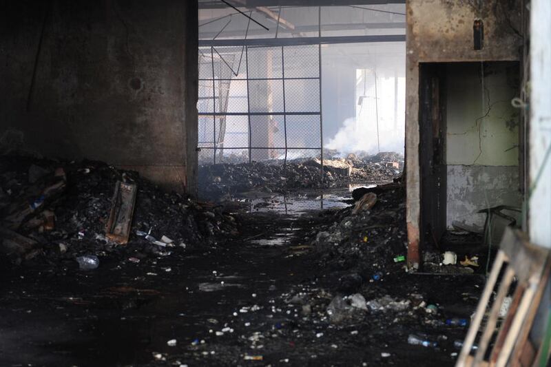 A view of the damaged premises of a cold-storage cargo facility. The charred bodies of seven Karachi airport workers who phoned their families as they hid in a cold-storage facility that was engulfed in flames during the attack were recovered by Pakistani authorities on June 10. Rizwan Tabassum/AFP Photo