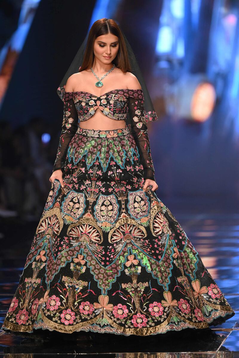 Bollywood actress Tara Sutaria presents a creation by designer Aisha Rao during a fashion show at the FDCI x Lakme Fashion Week in Mumbai. AFP