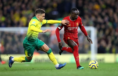 NORWICH, ENGLAND - FEBRUARY 15: Sadio Mane of Liverpool is challenged by Max Aarons of Norwich City during the Premier League match between Norwich City and Liverpool FC at Carrow Road on February 15, 2020 in Norwich, United Kingdom. (Photo by Julian Finney/Getty Images)