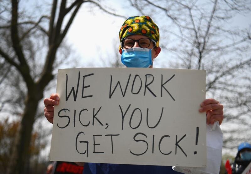 Healthcare workers of Jacobi Medical Center hold a rally against a new paid sick leave policy by NYC Health + Hospitals that mandates staff who are sick present a doctor's note. AFP