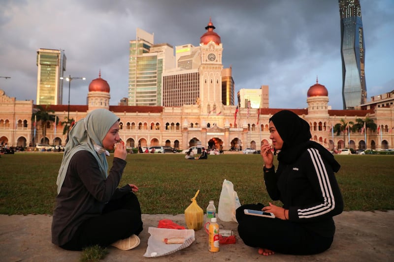 Women break their fast at Independence Square in Kuala Lumpur, Malaysia. Reuters