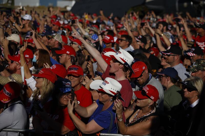 Attendees react as President Donald Trump speaks during a campaign rally on October 18, 2020. AFP