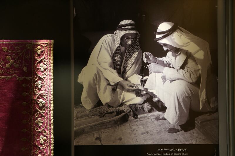 An old photograph of the pearl merchants on display at the museum.