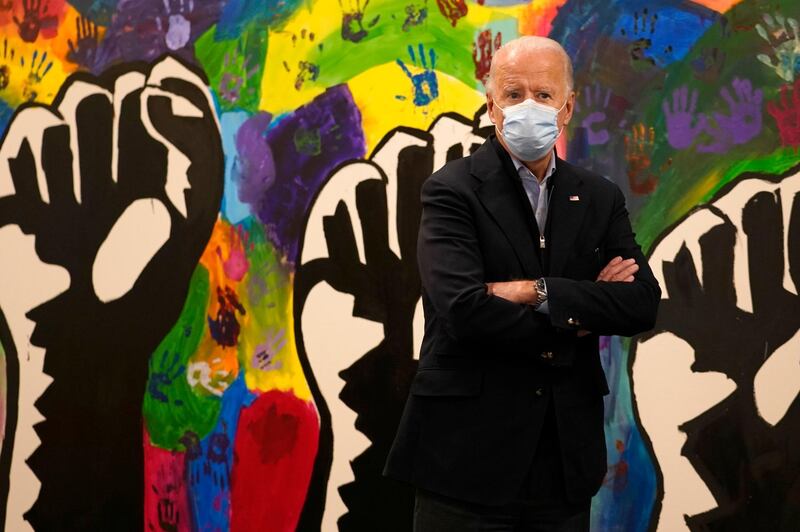Democratic presidential candidate former Vice President Joe Biden pauses in front of a mural during visit to The Warehouse teen centre in Wilmington, Delaware, November 3, 2020. AP Photo