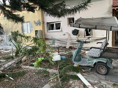A golf cart stands outside an abandoned home in Kibbutz Be'eri. Photo: Thomas Helm / The National