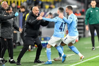 Manchester City manager Pep Guardiola celebrates with goal scorer Phil Foden and Kyle Walker (right) after their second goal during the UEFA Champions League, quarter final, second leg match at Signal Iduna Park in Dortmund, Germany. PA