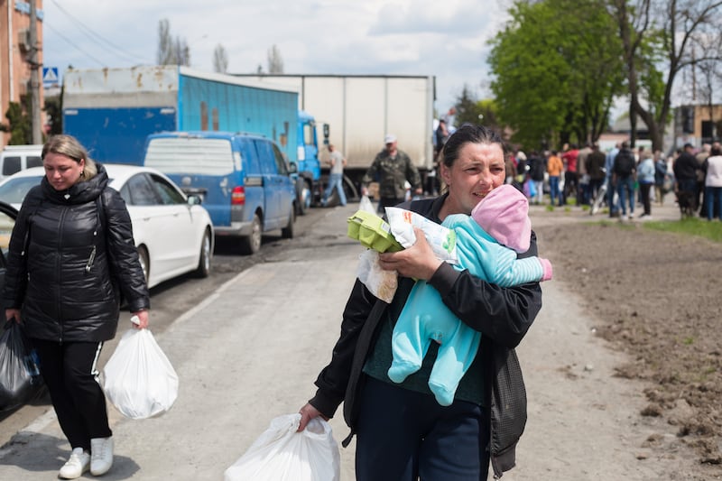 Residents collect humanitarian aid in Borodyanka, Ukraine. Getty Images