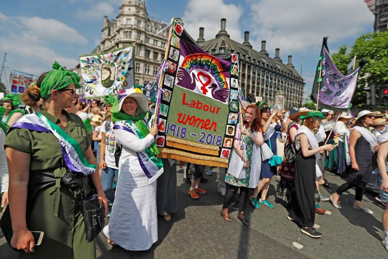 Women wear the suffragette colours of green, white and violet - standing for Give Women Votes - in the 'Processions' women's march in Westminster, London, Britain, June 10, 2018. REUTERS/Peter Nicholls