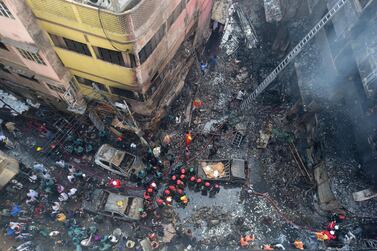 Firefighters work at the scene of an overnight fire in Dhaka on February 21, 2019. AFP