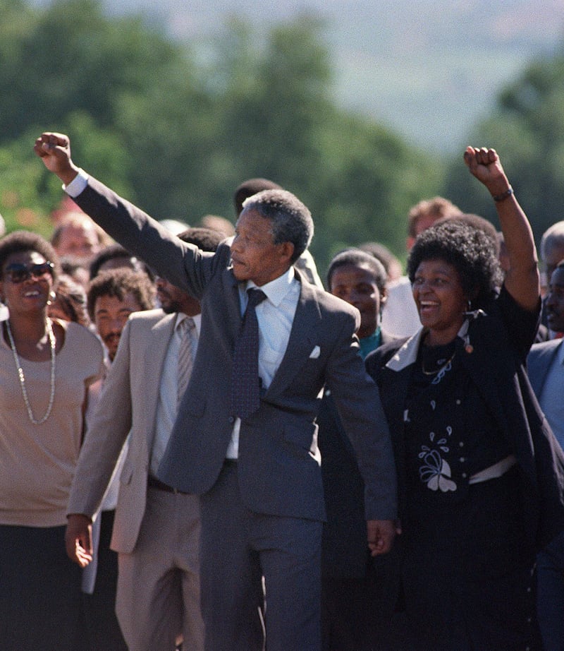 (FILES) A picture taken on February 11, 1990 shows Nelson Mandela (C) and his then-wife anti-apartheid campaigner Winnie raising their fists and saluting cheering crowd upon Mandela's release from the Victor Verster prison near Paarl. Rolihlahla Dalibhunga Mandela, affectionately known by his clan name "Madiba", became commander-in-chief of Umkhonto weSizwe (Spear of the Nation), the armed underground wing of the African National Congress, in 1961, and the following year underwent military training in Algeria and Ethiopia. After more than a year underground, Mandela was captured by police and sentenced in 1964 to life in prison during the Rivonia trial, where he delivered a speech that was to become the manifesto of the anti-apartheid movement. Mandela started his prison years in the notorious Robben Island Prison, a maximum security prison on a small island 7Km off the coast near Cape Town. In April 1984 he was transferred to Pollsmoor Prison in Cape Town and in December 1988 he was moved the Victor Verster Prison near Paarl. While in prison, Mandela flatly rejected offers made by his jailers for remission of sentence in exchange for accepting the bantustan policy by recognising the independence of the Transkei and agreeing to settle there. Again in the 'eighties Mandela rejected an offer of release on condition that he renounce violence. Prisoners cannot enter into contracts. Only free men can negotiate, he said, according to ANC reports.  AFP PHOTO FILES / ALEXANDER JOE / AFP PHOTO / FILES / Alexander JOE