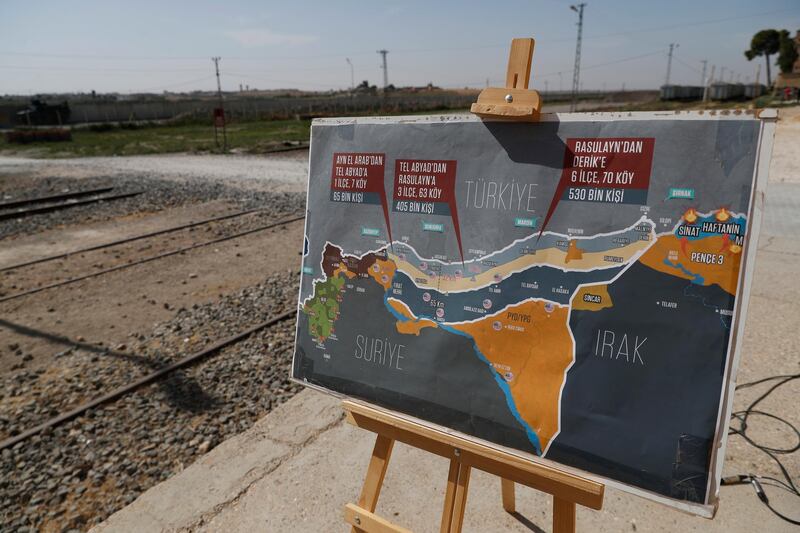 A map showing Turkey's suggested possible operation in Syria, used by a TV journalist, is seen at the border between Turkey and Syria, in Akcakale, Sanliurfa province, southeastern Turkey.  AP Photo