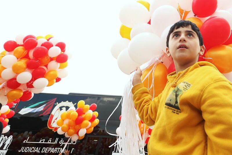 A student at Emirates National School for Boys in Mohammed Bin Zayed City holds onto balloons before they are released during the launch of the Children's Legal Knowledge Year activity at the school. Delores Johnson / The National