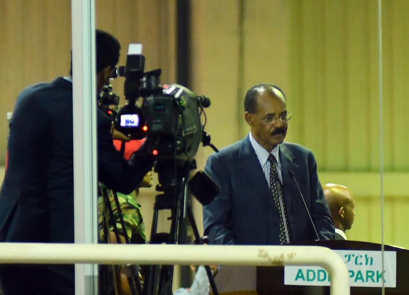 epa06891182 Eritrea's President Isaias Afwerki (C) addresses a crowd behind safety glass at an celebrational event for at Millennium Hall in Addis Ababa, Ethiopia, 15 July 2018. Afwerki's historic visit comes days after Ethiopia's Prime Minister Abiy Ahmed visited Eritrea where the two warring countries declared an end to the state of war. Afwerki is visiting Ethiopia for the first time since the two countries started its border war in 1998.  EPA/DANIEL GETACHEW BEST QUALITY AVAILABLE