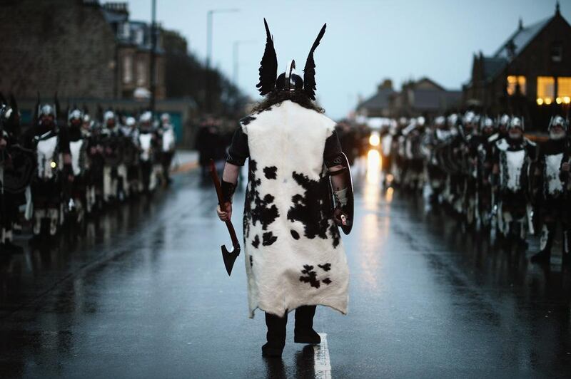 A man leads the march of 1000 men dressed as Vikings. Jeff J Mitchell / Getty Images