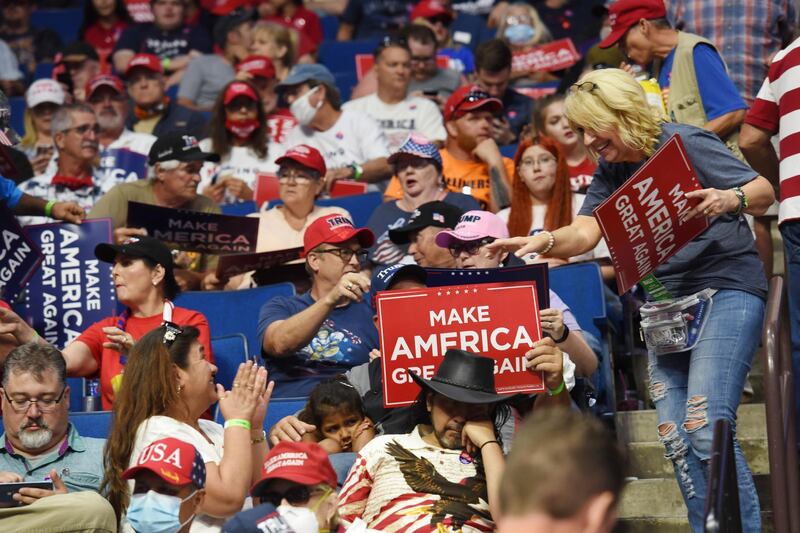 Supporters of US President Donald Trump hold placards during a rally inside the Bank of Oklahoma Centre in Tulsa. EPA