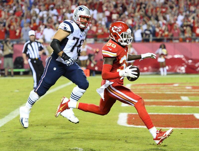 Kansas City Chiefs player Husain Abdullah, right, runs the ball in for a touchdown against the New England Patriots on Monday night in the NFL. Larry W Smith / EPA / September 29, 2014
