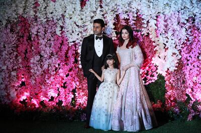 epa07427403 Bollywood actors Abhishek Bachchan (L) and his wife Aishwarya Rai Bachchan with their daughter Aaradhya pose as they arrive to attend the wedding reception of Akash Ambani, son of Reliance Industries Chairman Mukesh Ambani, in Mumbai, India, 10 March 2019. Akash Ambani got married to Shloka Mehta on 09 March 2019.  EPA-EFE/DIVYAKANT SOLANKI