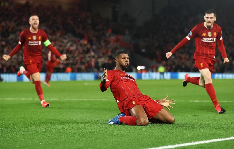 Georginio Wijnaldum of Liverpool celebrates with Jordan Henderson and Andy Robertson after scoring his team's first goal. Getty Images