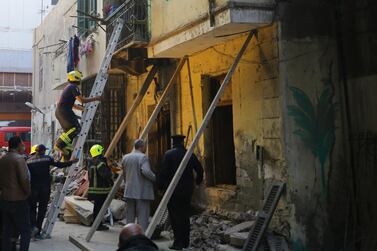 Egyptian rescue workers inspect the site of a three-storey building that collapsed in Roud Al Farag, Cairo, on Monday, February 15 2021. The authorities said at least three people died. EPA