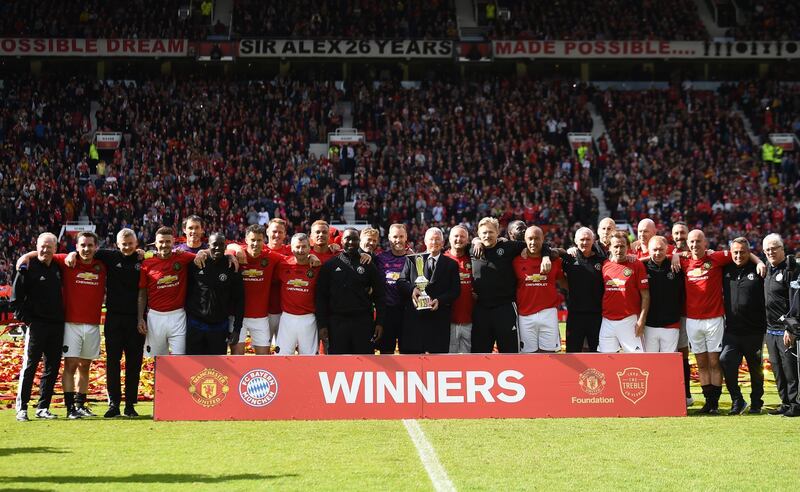 Manchester United 99 Legends hold the winners' trophy after beating Bayern Munich 5-0. Getty