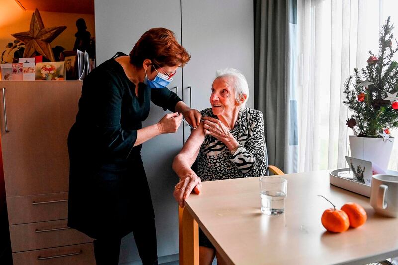Resident Maria receives a Pfizer-BioNTech Covid-19 vaccine at a care home in Puurs, Belgium as the country starts its national vaccination campaign. AFP