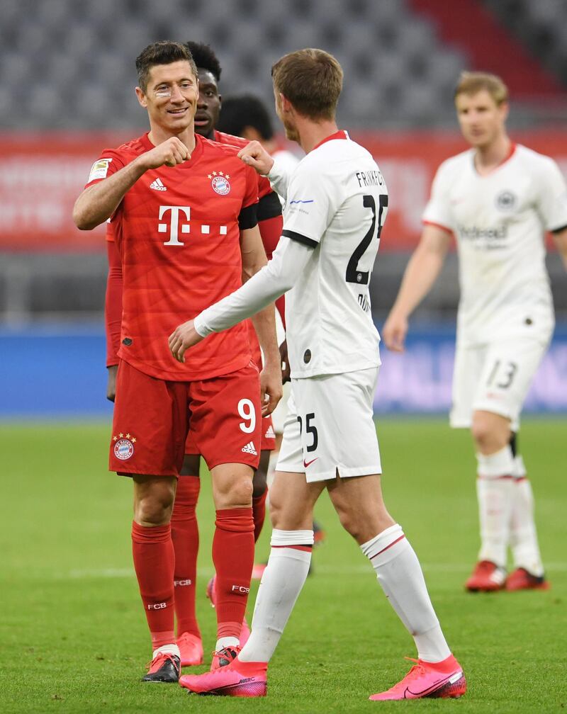 Bayern Munich's Robert Lewandowski, left, greets Frankfurt's Erik Durm. AFP