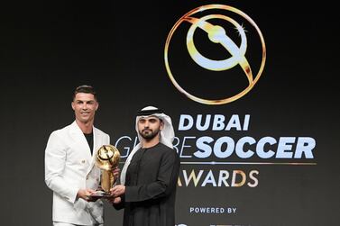 Cristiano Ronaldo receives his award from Sheikh Mansour bin Mohammed. Reuters