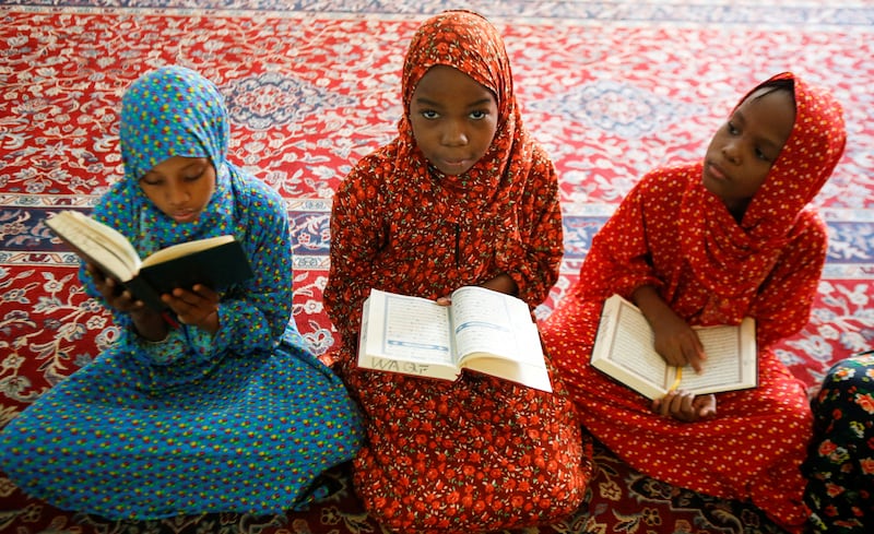 Muslim girls read the Quran before the start of the Friday prayers at the Jamia mosque in Nairobi, Kenya. Reuters