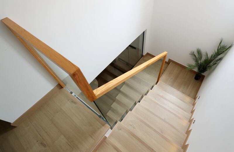 The stairs have a glass bannister