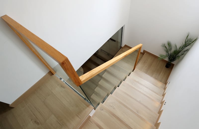 The stairs have a glass bannister