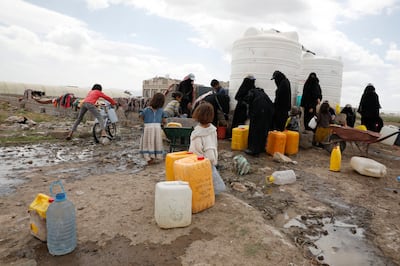 Yemeni women gather to fill up jerrycans with water from a donated tank on the outskirts of Sanaa. EPA