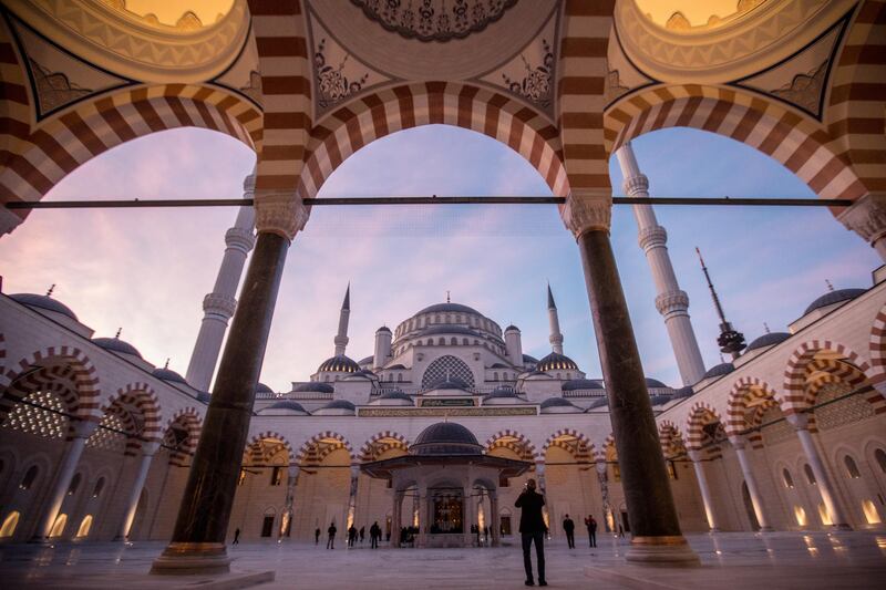 A man takes a photograph in the courtyard of Camlica mosque after taking part in the first official public prayer marking the opening of Camlica Mosque in Istanbul, Turkey. Camlica Mosque is now Turkey's largest mosque capable of accommodating more than 40,000 people. The mosque sits on Camlica hill with sweeping views over Istanbul. Construction on the mega project, which was championed by Turkey's president Recep Tayyip Erdogan, started in 2013 at a cost of approximately 150 million Turkish Lira. The mosque was designed by two female architects and includes a museum, art gallery and library.  Getty Images