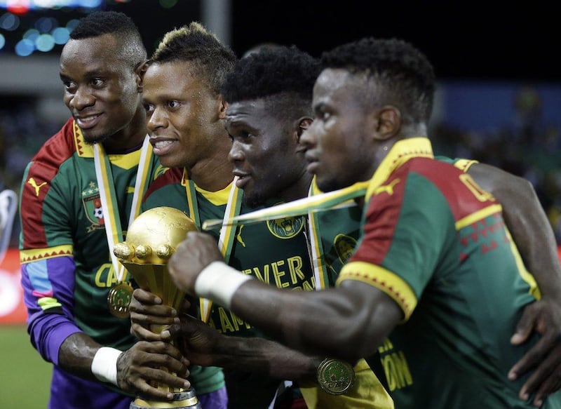 Cameroon players pose with the trophy after winning the Africa Cup of Nations final against Egypt at the Stade de l'Amitie, in Libreville, Gabon, Sunday, February 5, 2017. Cameroon won 2-1. Sunday Alamba / AP Photo