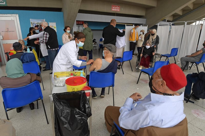 Elderly people wait to get vaccinated against COVID-19 at El-Menzah sports hall in Tunisia's capital Tunis on May 3, 2021.  / AFP / FETHI BELAID
