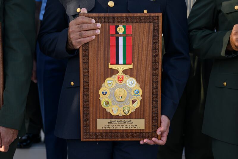 A member of the Armed Forces with a medal presented at the unification ceremony