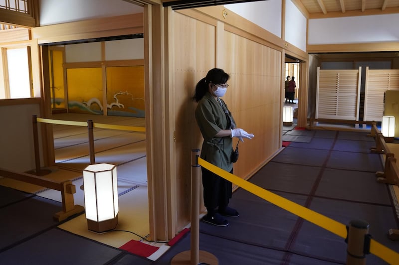 A worker wearing a protective mask and gloves stands inside the Nagoya Castle Hommaru Palace in Nagoya, Aichi Prefecture, Japan. Bloomberg